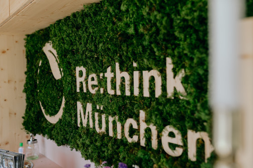 Eine grüne Wand aus Moos trägt den weißen Schriftzug 